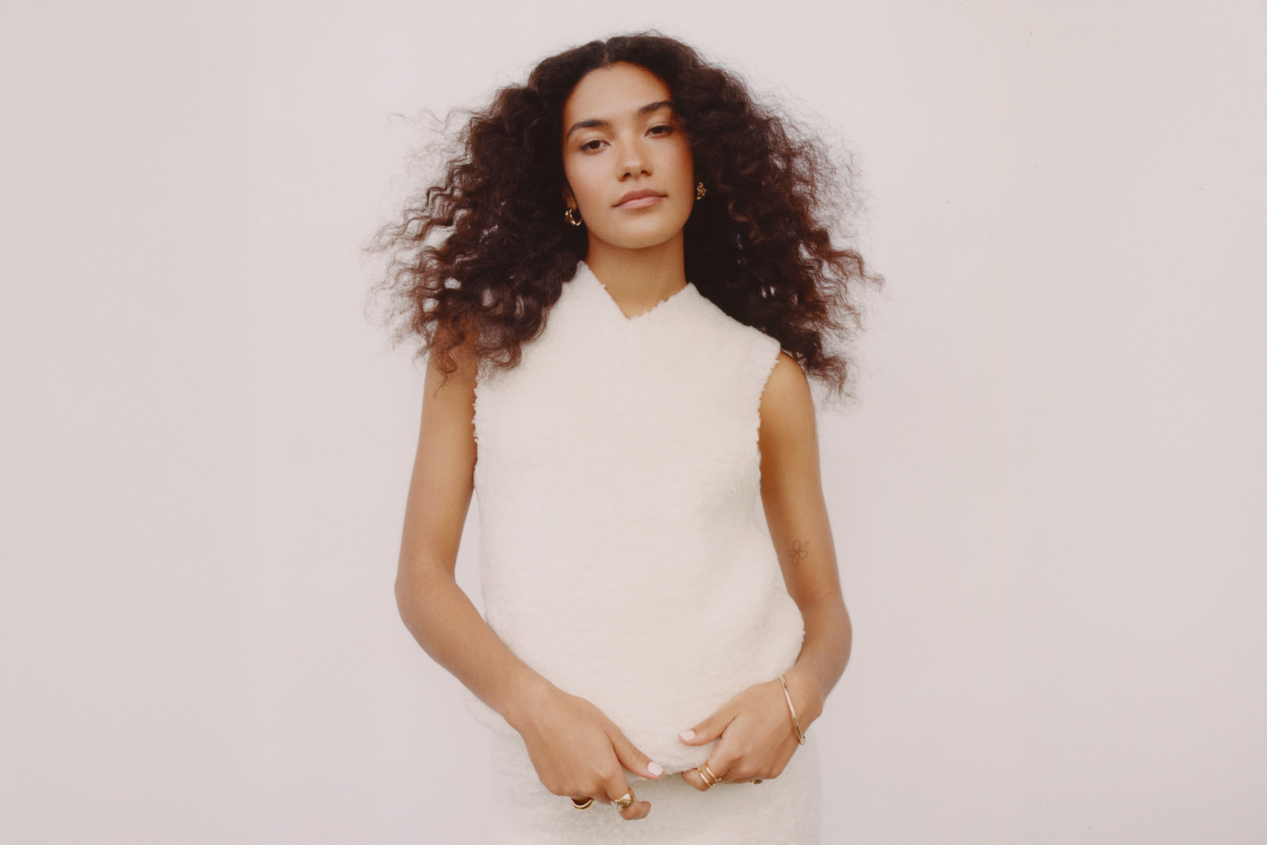 Olivia Dean goes plane spotting in her new video for recent single ‘Time’