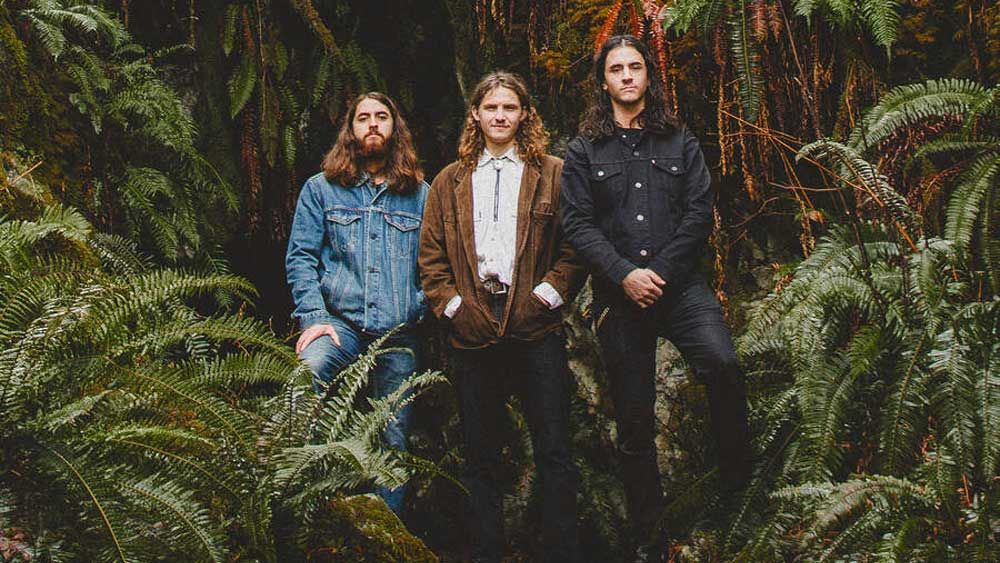 “The jams that turned into songs on the album began with us playing out in the woods at night. Crazy spirit.” Meet Ever Age: The 21st-century power trio whose debut album might just be a once-in-a-generation record