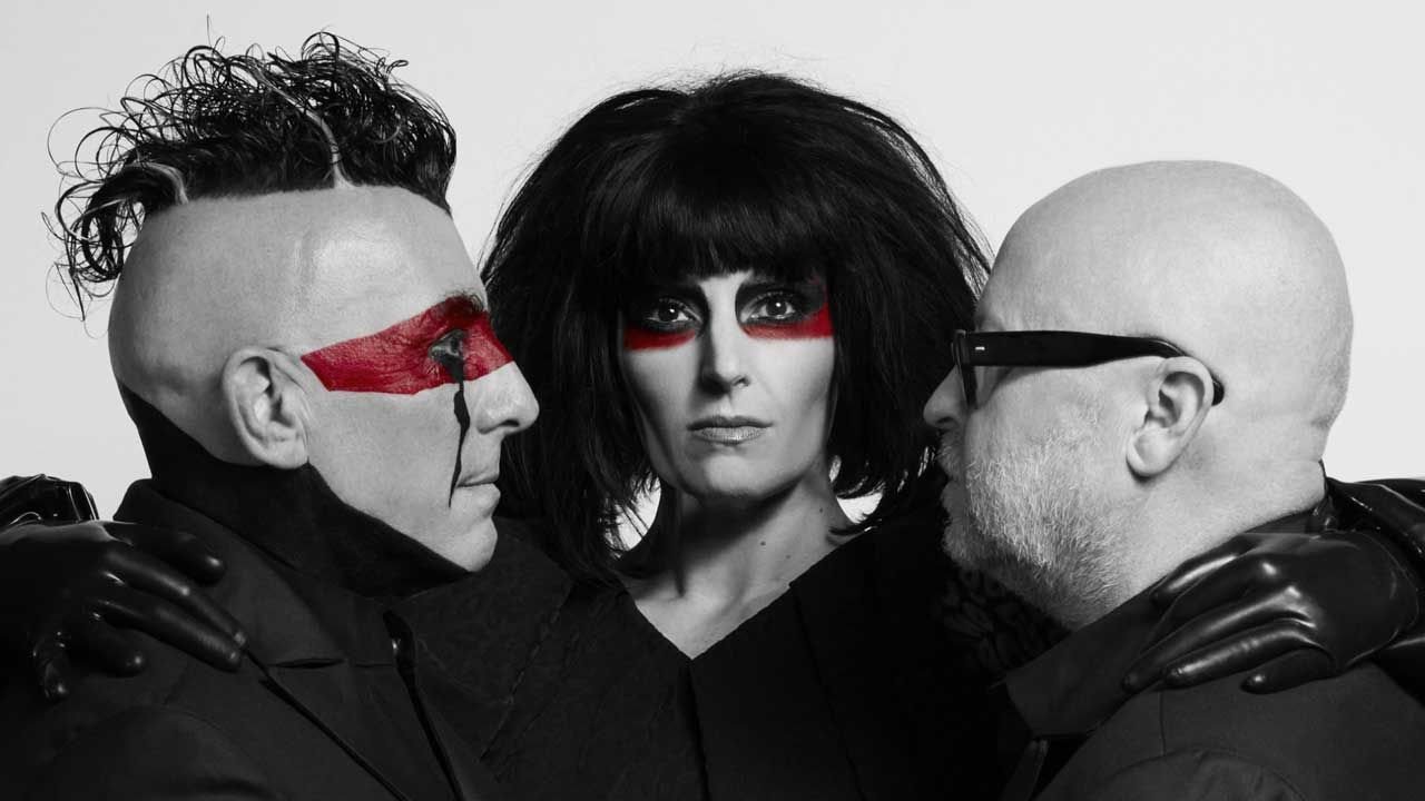 “There are a lot of people who don’t seem interested or even notice that the world’s on fire.” Puscifer’s Maynard James Keenan and Carina Round discuss soundtracking the end times